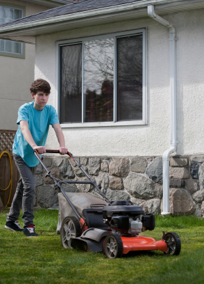 teenager mowing lawn