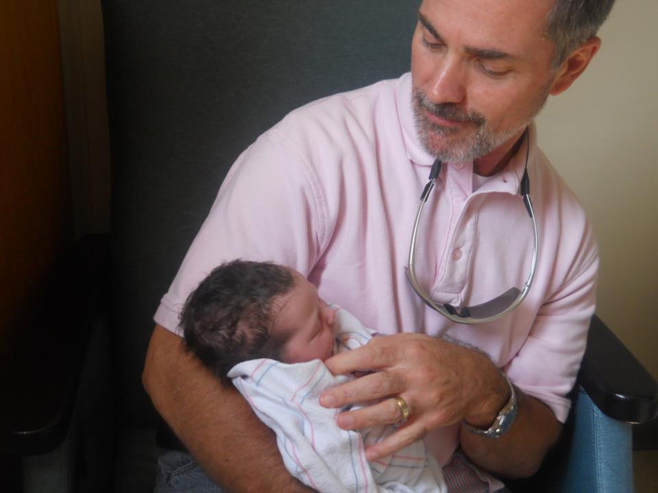 Derek Logan with his newborn granddaughter