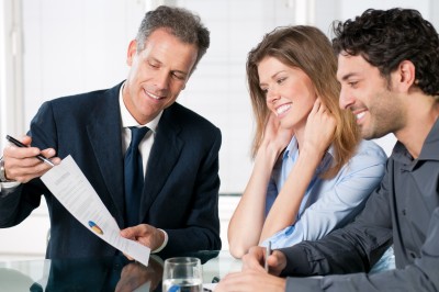 Picture showing a Bank On Yourself Professional explaining the Bank On Yourself strategy to a young couple