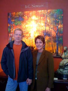 Founder and President Pamela Yellen and husband Larry with BC Nowlin painting